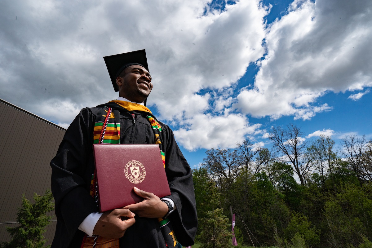 Graduate with diploma in regalia