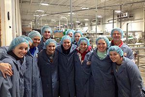 people in a group photo wearing coats and hairnets