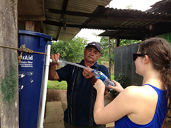 student working with a man in Costa Rica