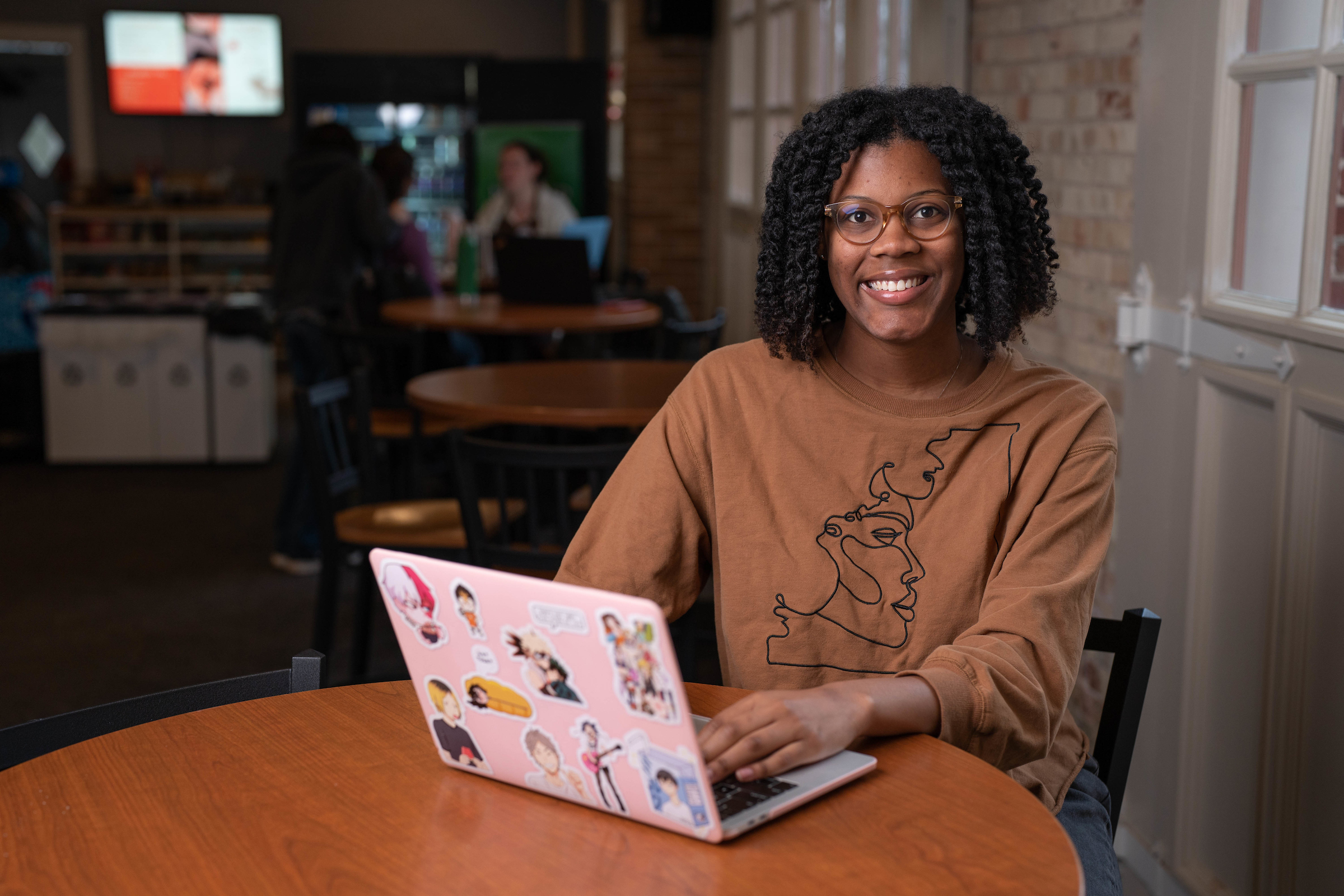 Macayla Jones working on a laptop at a table at The Moose