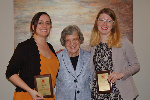 Students with awards posing with an older woman