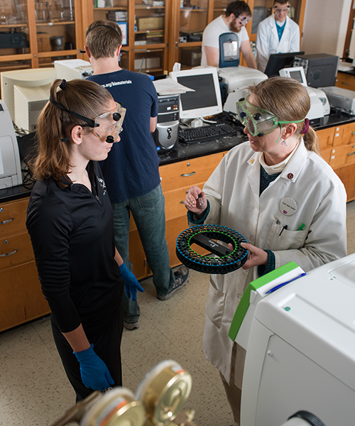 Student and professor observing lab