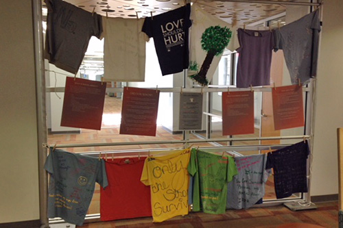 different tshirts with writing on them hanging in hallway