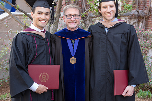 students holding diplomas 