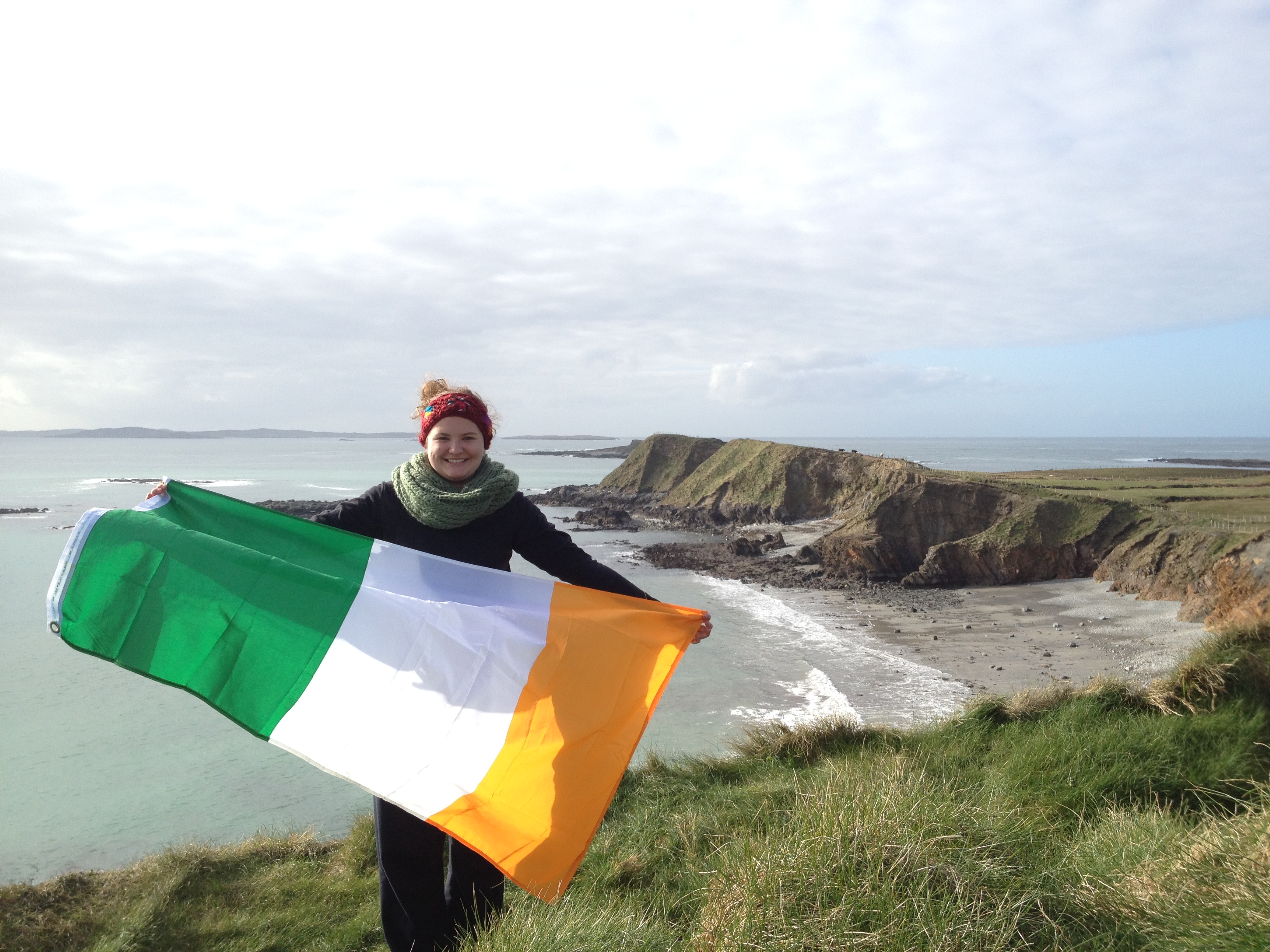 student holding an irish flag