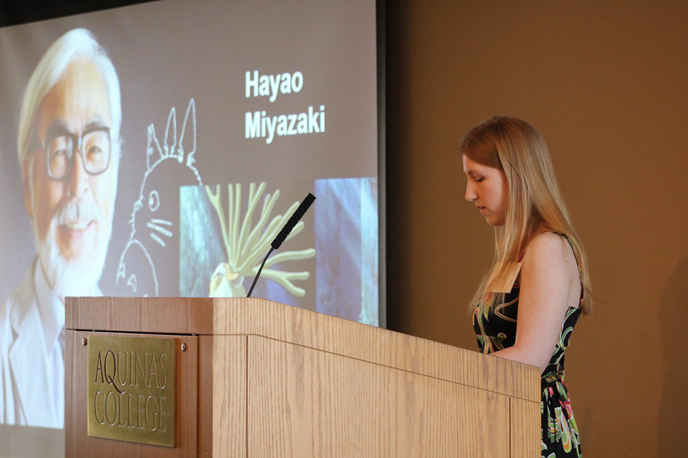 student standing at podium giving speech 