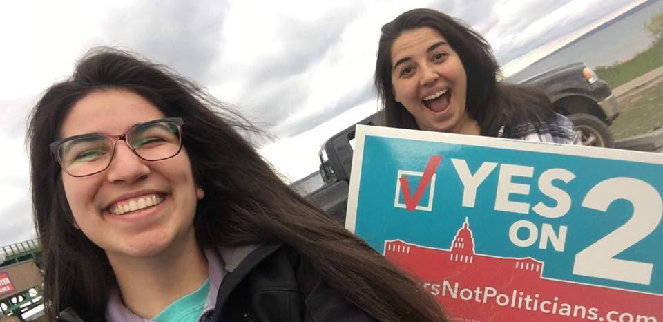 two women holding posters