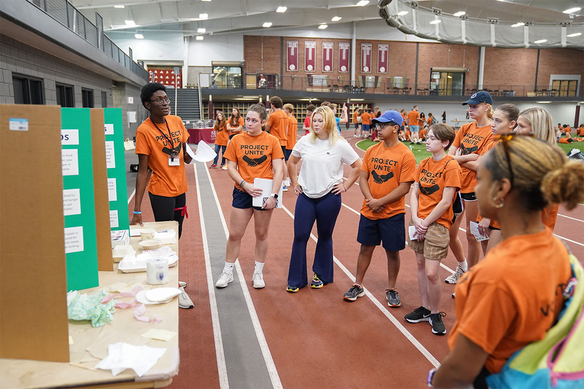 People dressed in orange learning about zero waste 