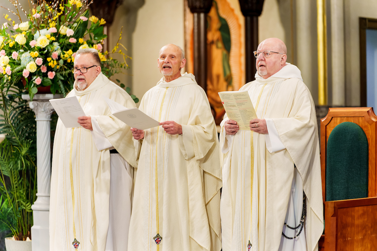 Father Stan with two other Dominican priests, singing