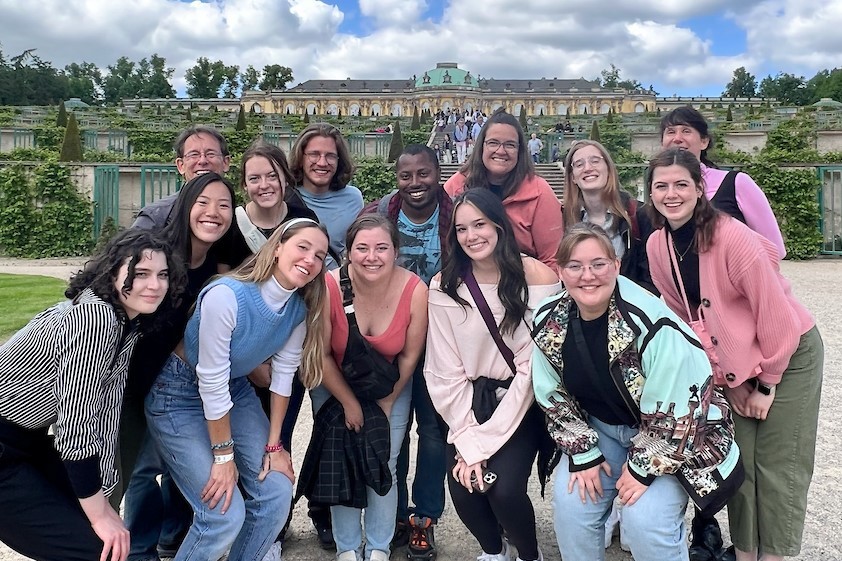 Students posing in front of a palace