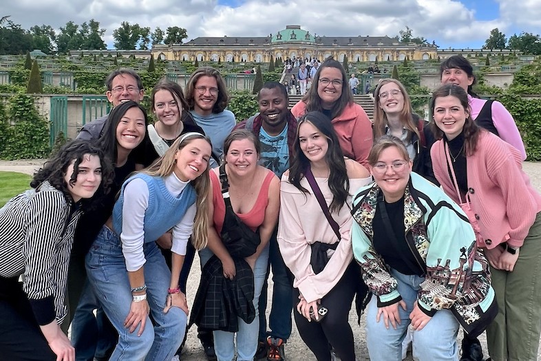 Students posing in front of palace