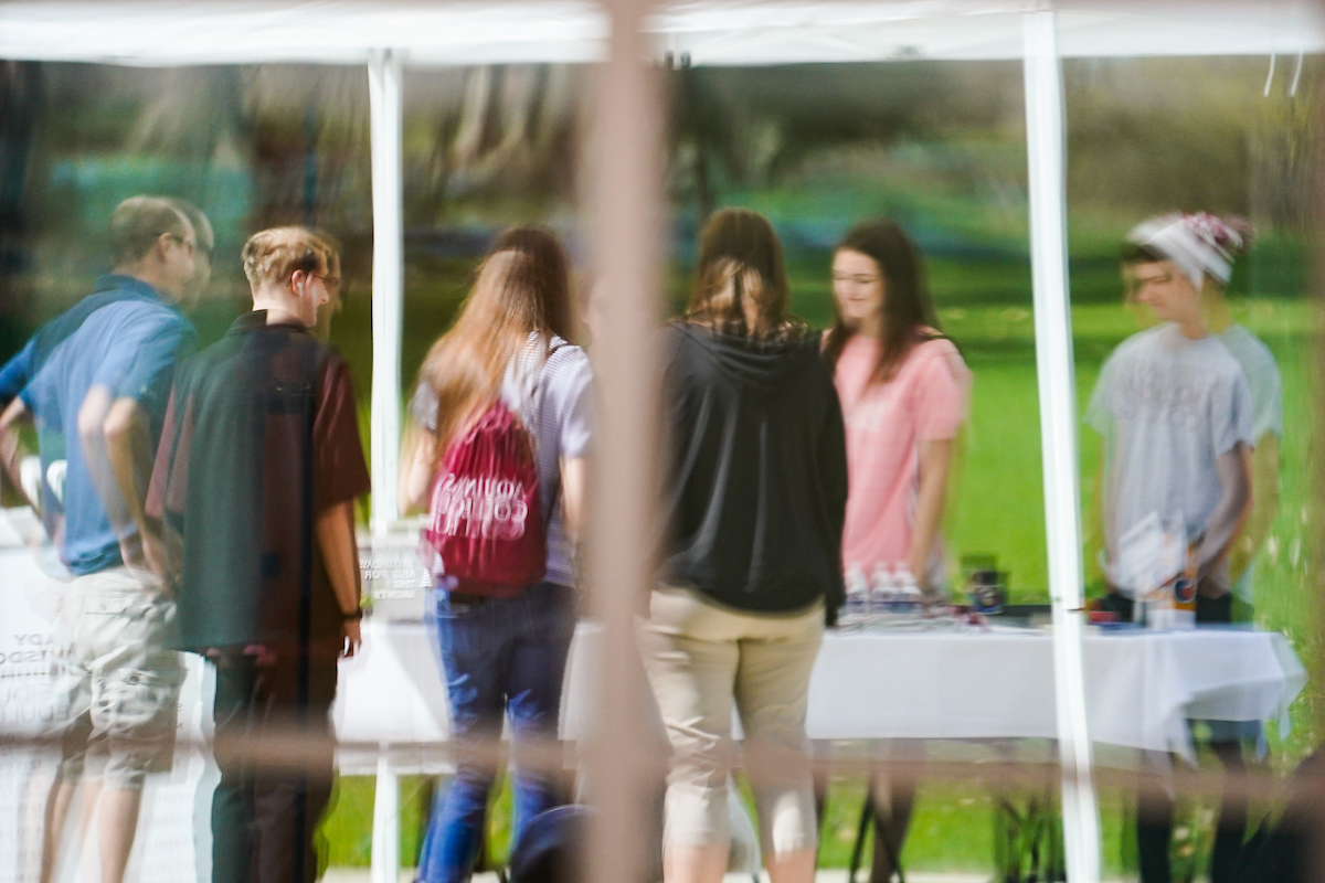 students standing at a table outside