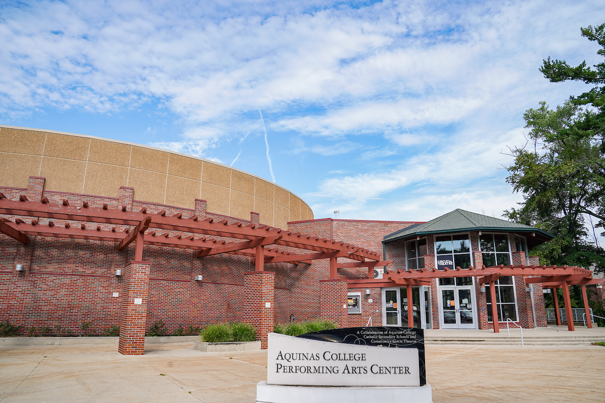 The Performing art Center, a brick building set against blue sky.