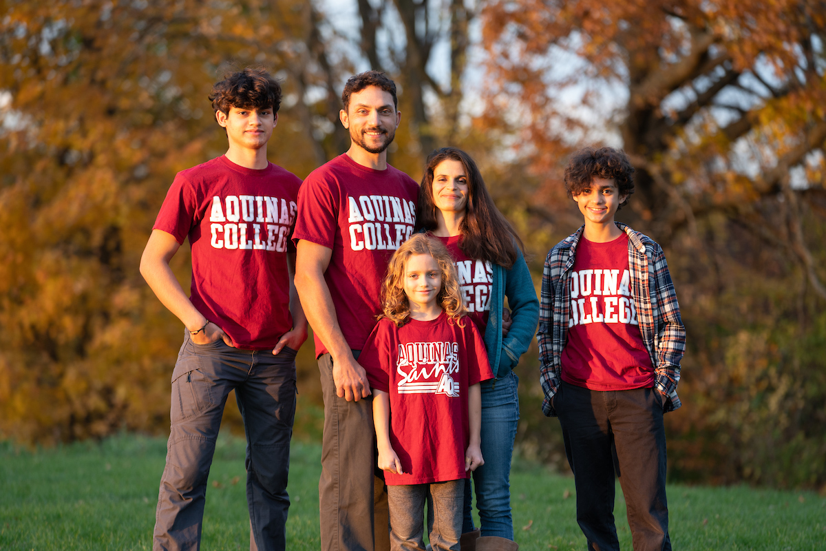 Family with three kids in AQ shirts