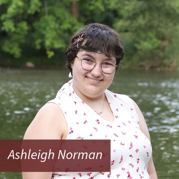 Headshot of a girl with short, dark hair in front of a river. Text reading: Ashleigh Norman