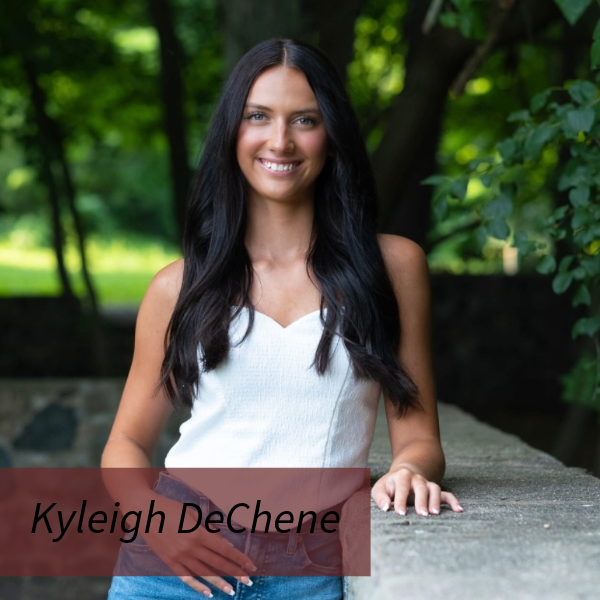 Photo of a girl with long, dark hair, next to a fence. Text reading: Kyleigh DeChene.