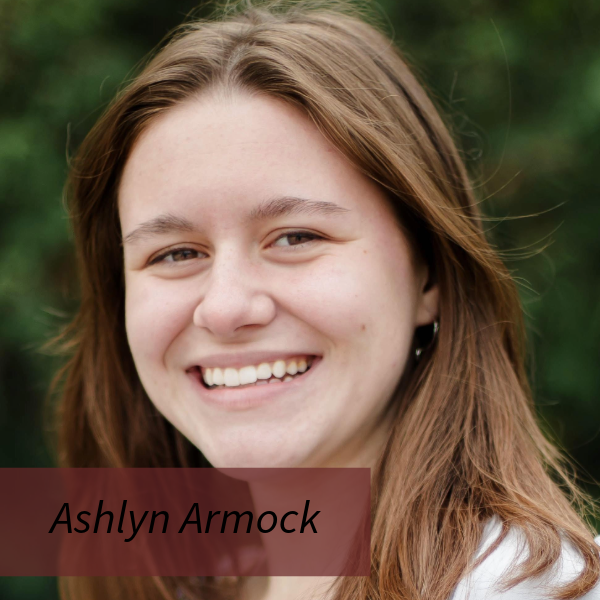 Headshot of a girl with shoulder length, light brown hair, standing outside. Text reading: Ashlyn Armock, Writing Center Consultant.