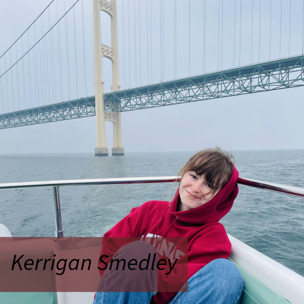 Picture of a girl with dark bangs, in an Aquinas College sweatshirt and blue jeans, in a boat under the Mackinac Bridge. Text reading: Kerrigan Smedley, Writing Center Consultant.