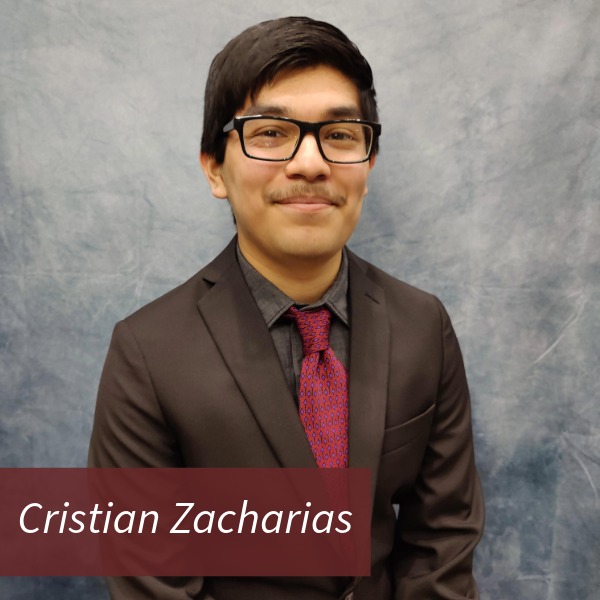 Headshot of a boy with dark hair, glasses, and a mustache in front of a gray backdrop. Text reading: Cristian Zacharias, Writing Center Consultant.