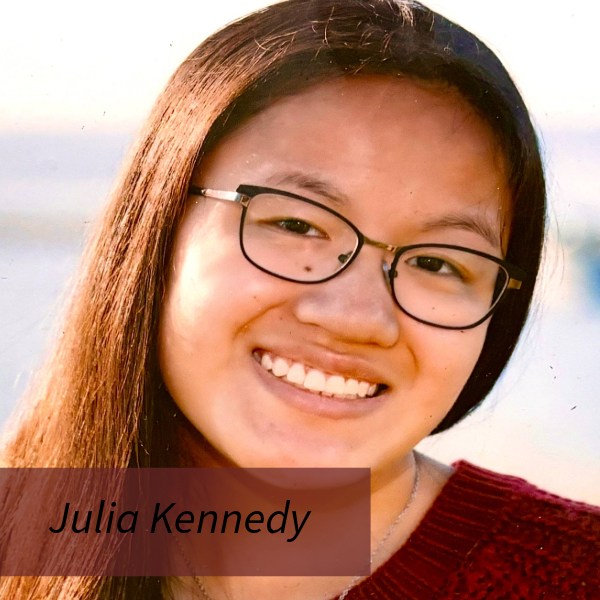 Headshot of a girl with long dark hair and glasses in a red sweater. Text reading: Julia Kennedy, Writing Center Consultant.
