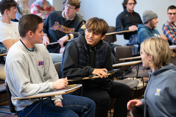 Marketing students talking together in a classroom