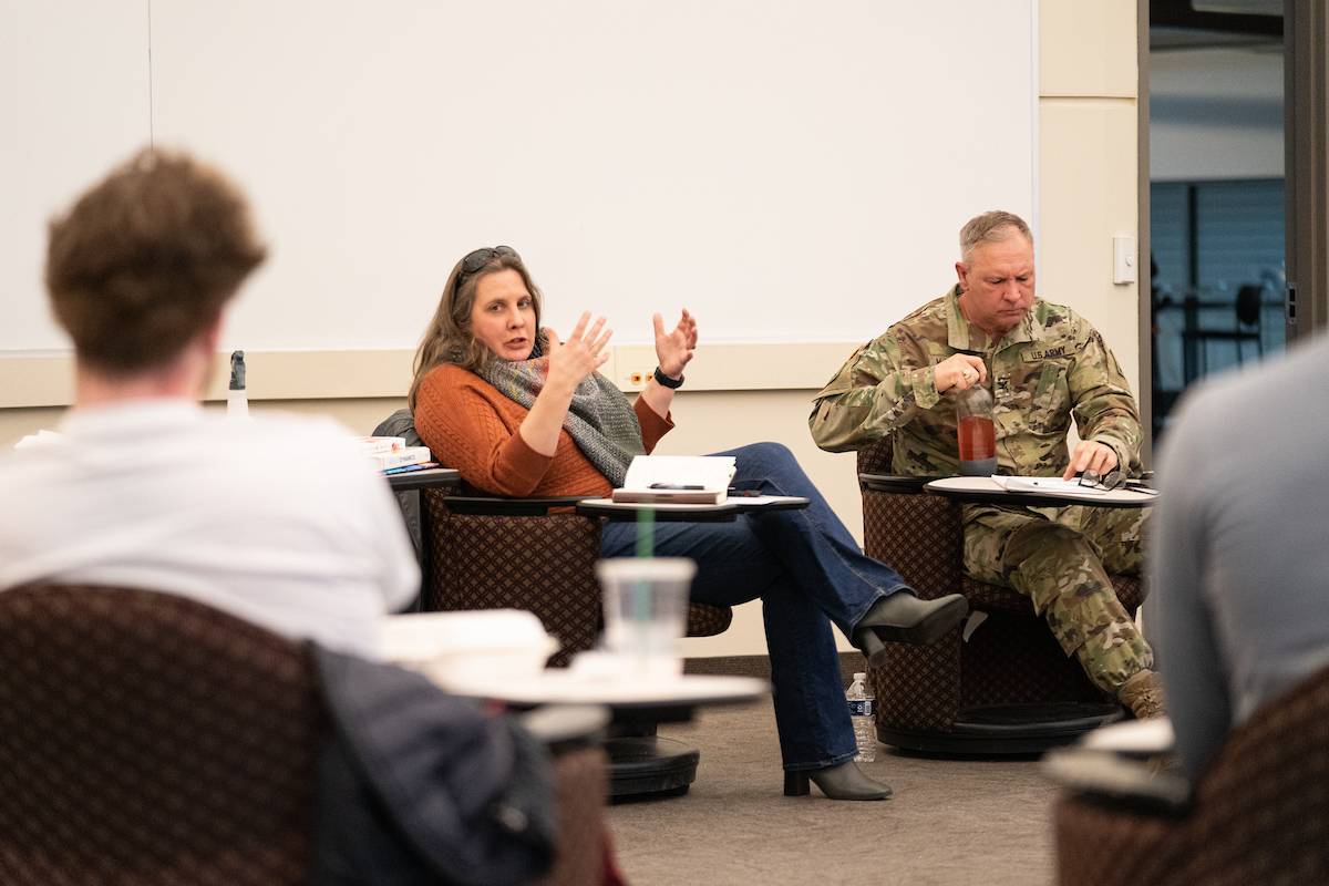 Students talking, one in army uniform