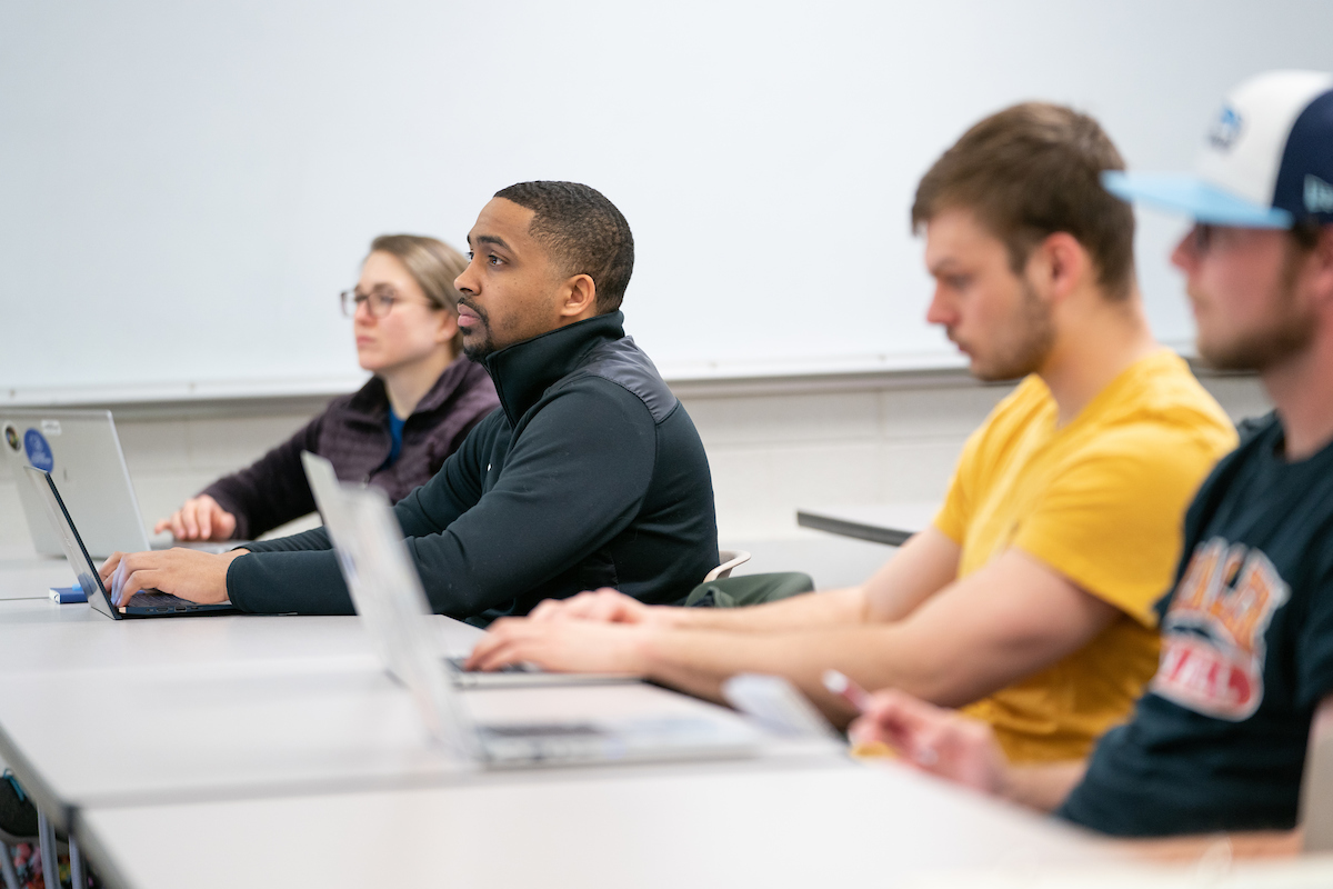 Students at laptops in a clasroom