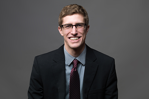 Smiling student in a suit and tie