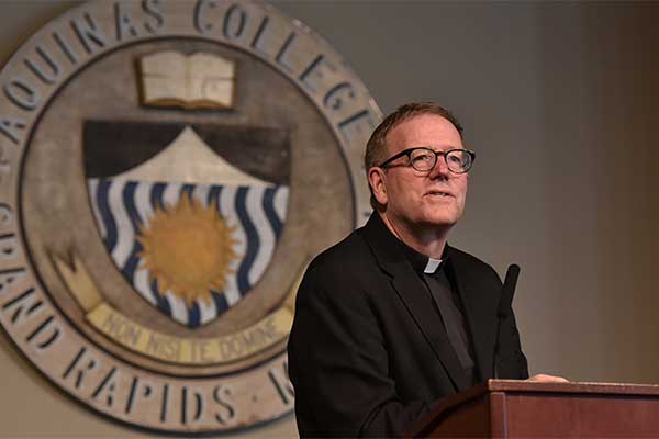 Speaker wearing clerical collar