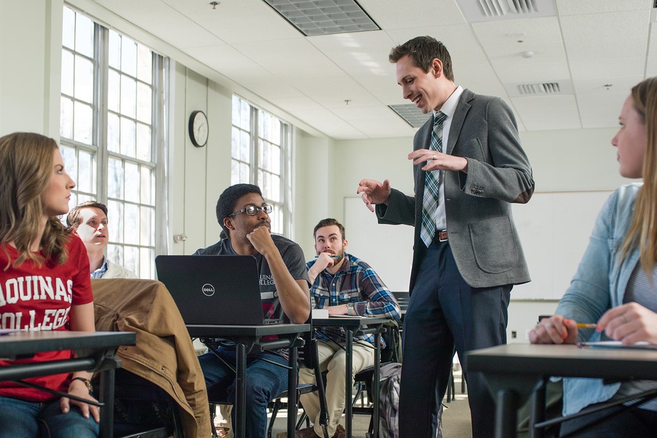 Communications professor speaking to students in a classroom