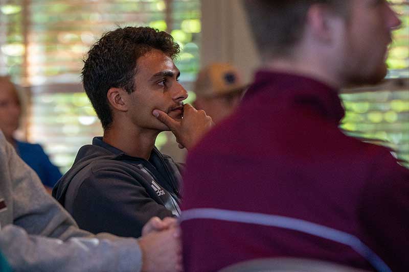 Aquinas students engaged in business presentation