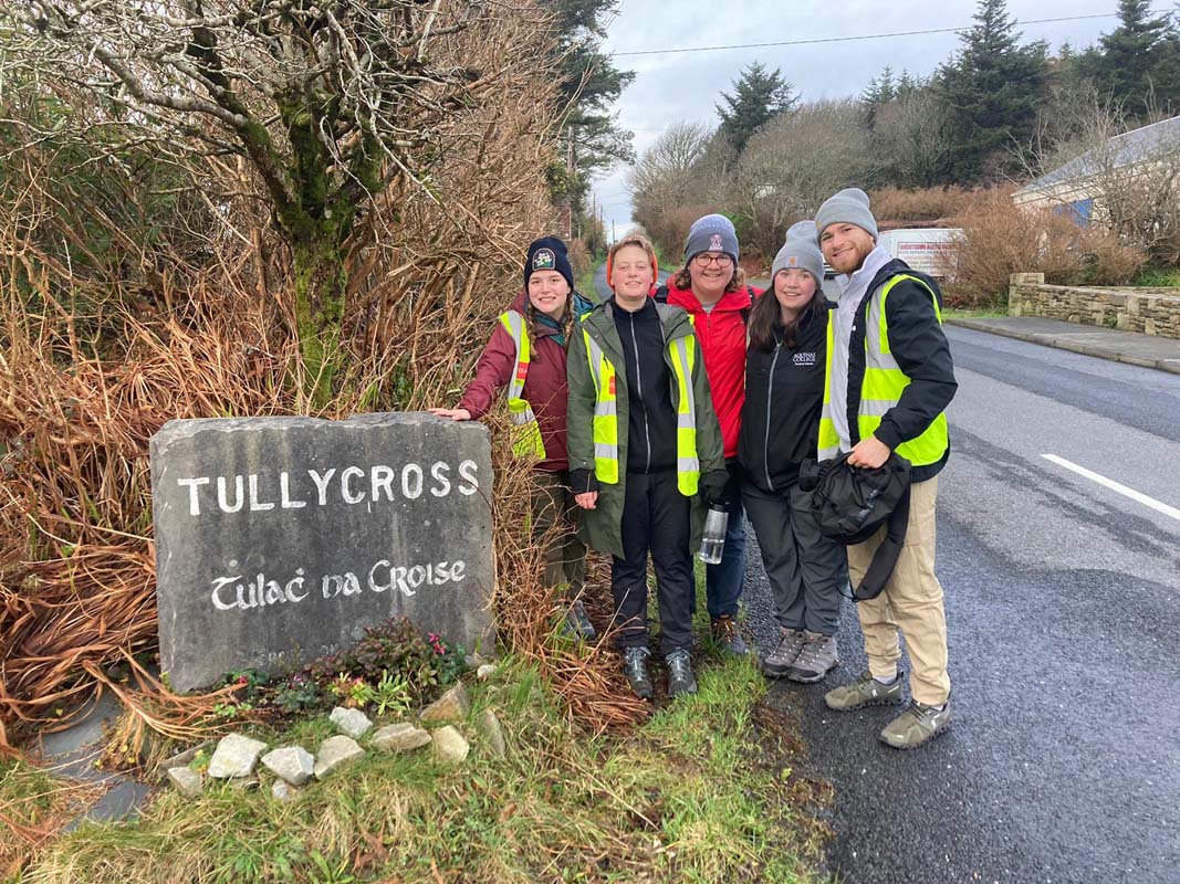 Students with rock carved to read Tully Cross Tulach Na Croise