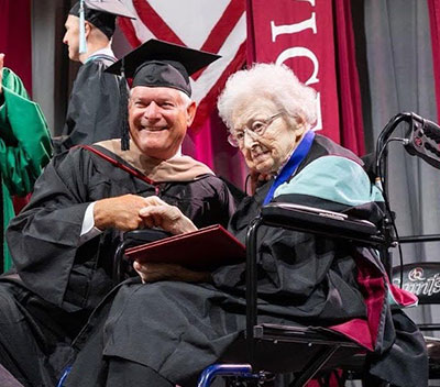 John Lowery with Sr. Aquinas at Commencement in 2024