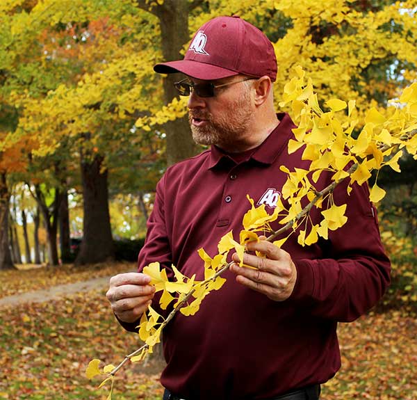 Ryan Wendt giving a tree tour on Aquinas College