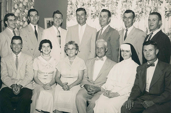 In August 1947, Sister Aquinas returned to Kingsley to celebrate the 64th birthdays of her parents with her nine brothers and sister. It was her first visit home since joining the Dominicans because Sisters-in-training were allowed only one visit in three years. Back row, left to right, brothers Paul, Ray, Ambrose, Jay, Dan, Clarence, and Carl. Front row, brother Jack, sister Marguerite (Marge), mother Anna, father Jacob, Sister Aquinas, and brother Vincent.